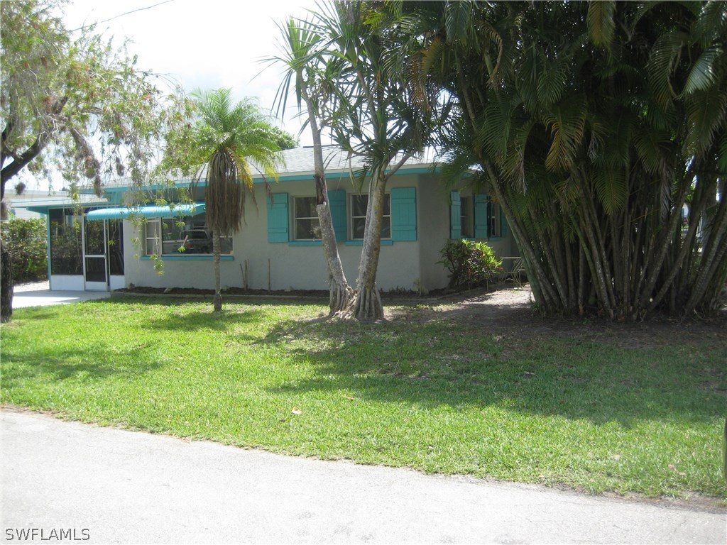 2567 Cay Cove Matlacha, FL 33993 - Photo 2 of 18 a view of a house with a yard