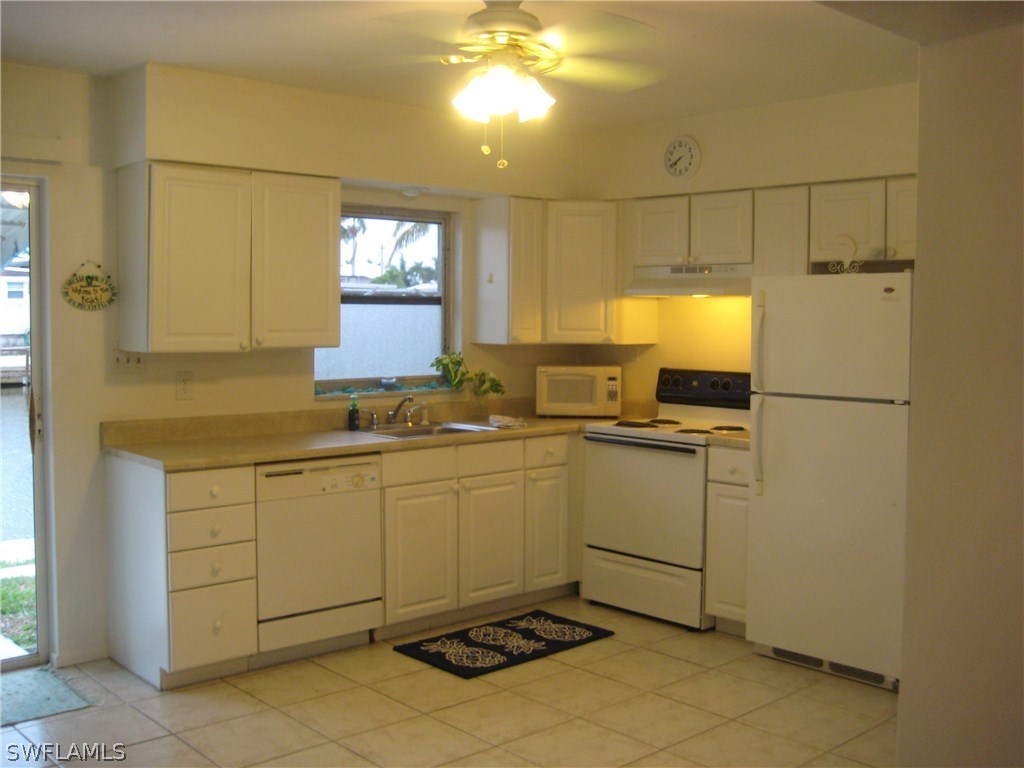 2567 Cay Cove Matlacha, FL 33993 - Photo 5 of 18 a kitchen with sink cabinets and appliances