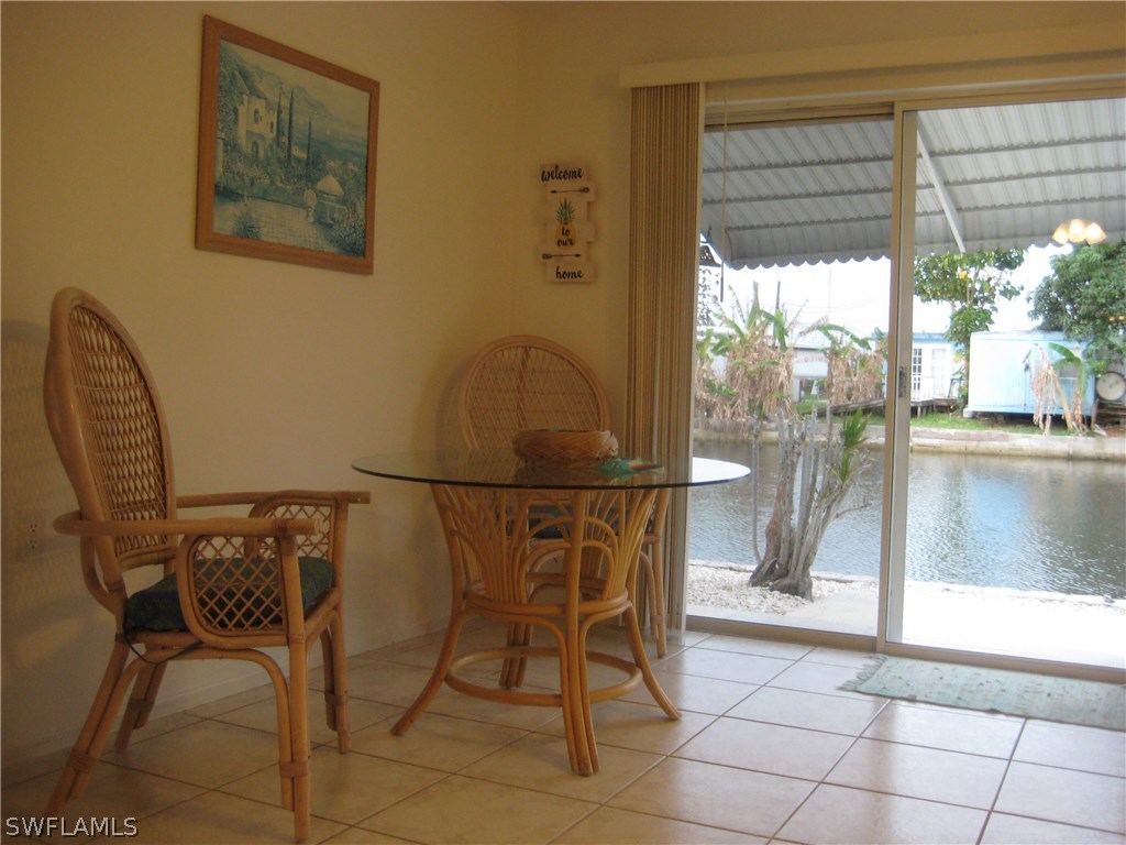 2567 Cay Cove Matlacha, FL 33993 - Photo 6 of 18 a view of a dining room with furniture and a floor to ceiling window
