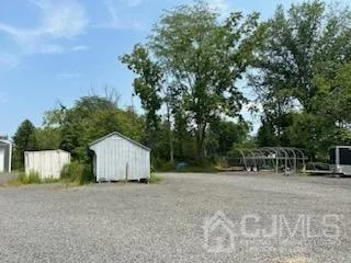 a view of backyard with table and chairs and wooden fence