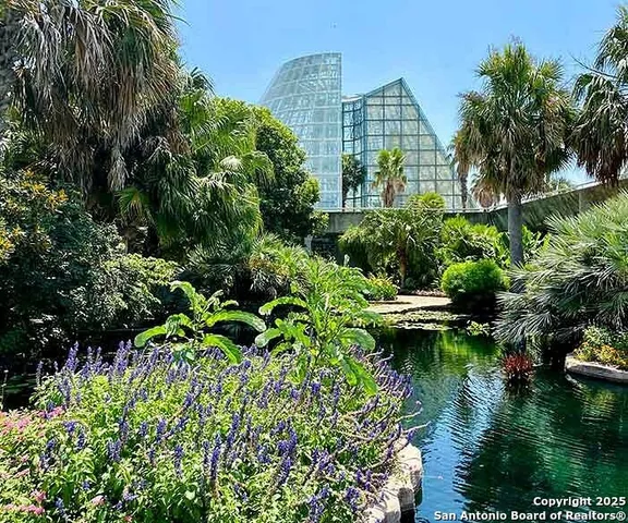 a view of a house with a yard and a garden