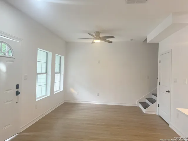 wooden floor in an empty room with a window