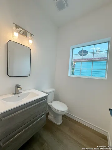 a bathroom with a toilet sink and mirror
