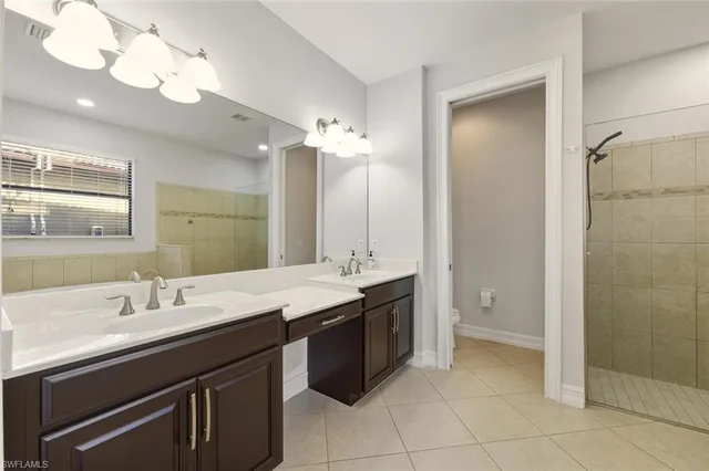 an empty room with wooden floor ceiling fan and windows