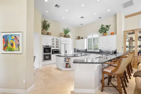 a kitchen with stainless steel appliances granite countertop a stove and a refrigerator