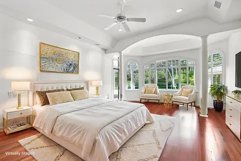 a spacious bedroom with a large bed and a large window