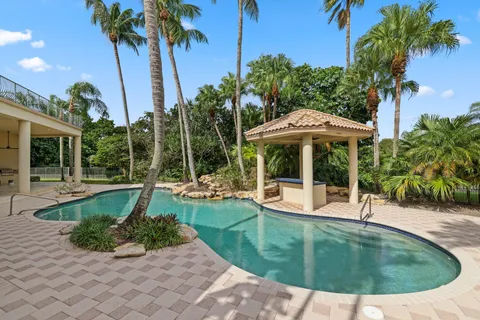 a view of a house with swimming pool and sitting area