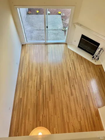 a view of a room with wooden floor