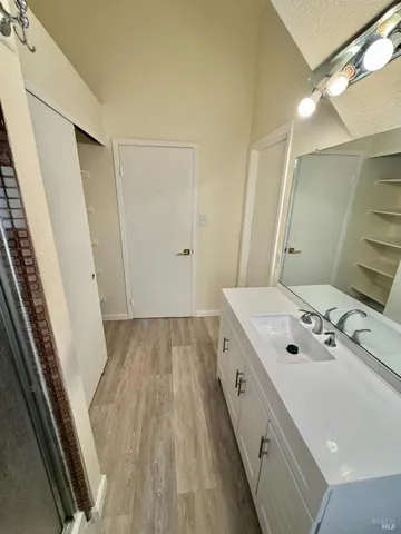 a view of a room with a ceiling fan and window