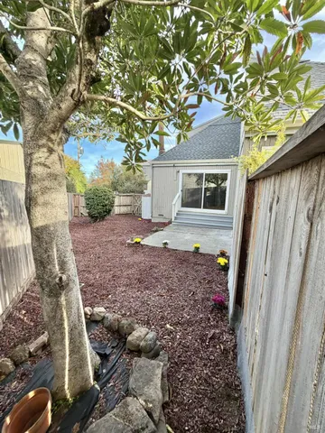 a view of backyard with a garden and deck