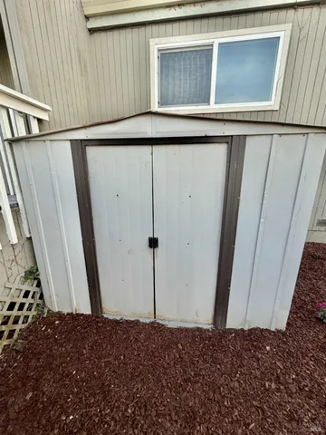 a view of a backyard with wooden fence