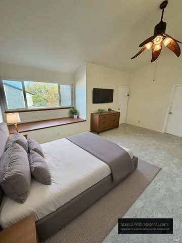 a bedroom with a bed and a television