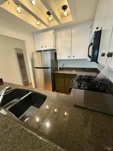 a kitchen with a sink and a refrigerator