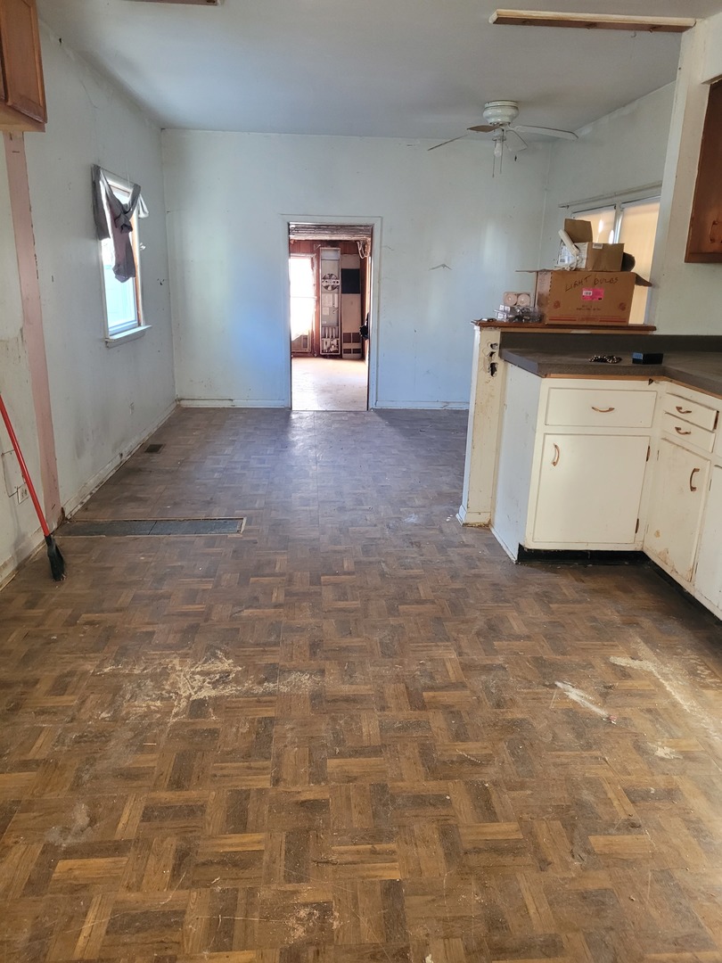 7911 45th Street Lyons, IL 60534 - Photo 15 of 15 a kitchen with granite countertop a stove a sink and a white cabinets