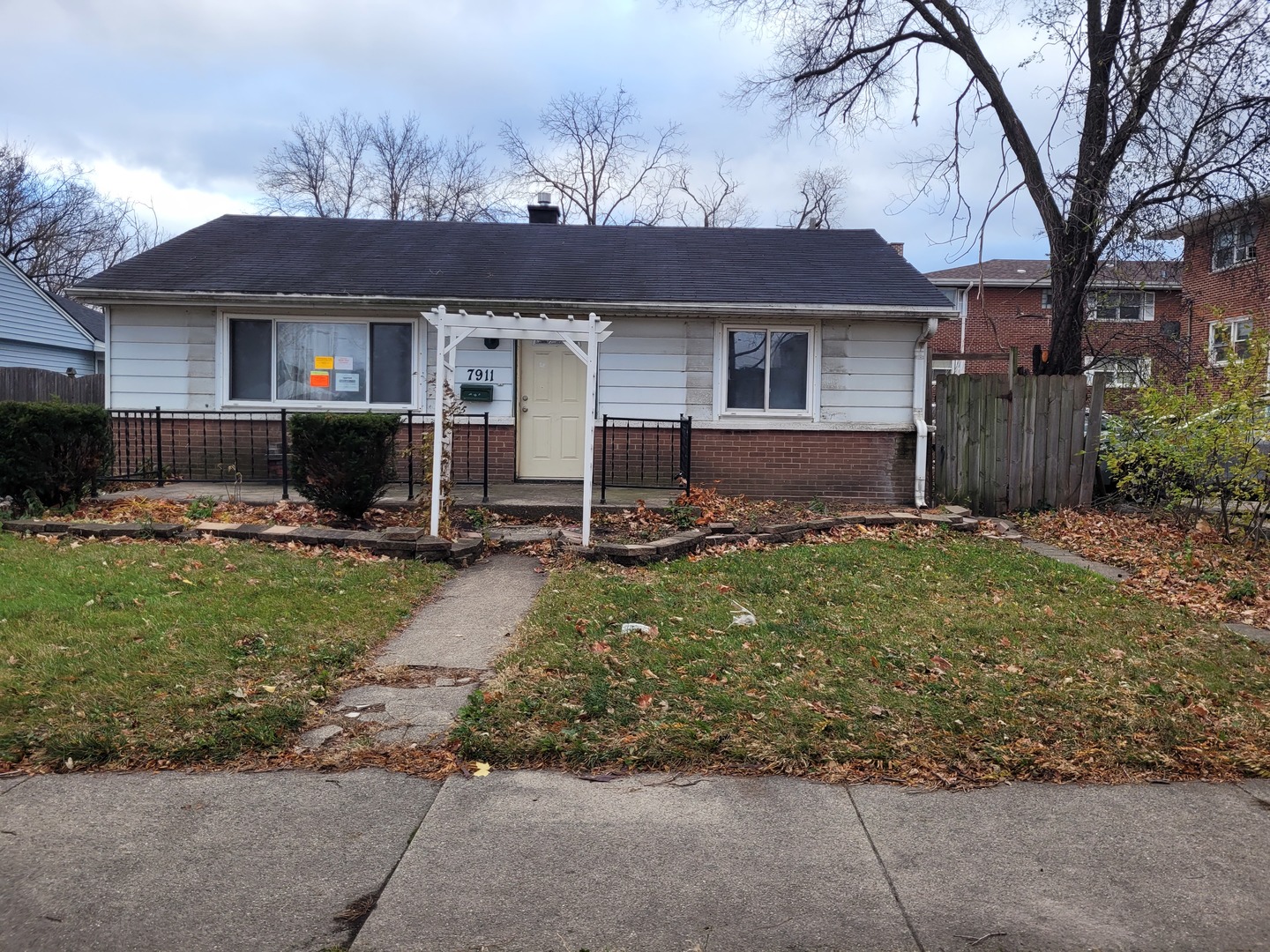 7911 45th Street Lyons, IL 60534 - Photo 2 of 15 a front view of a house with garden