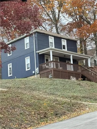 a house that has tree in front of it