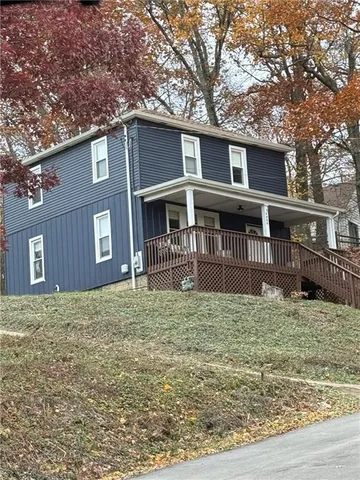a house that has tree in front of it