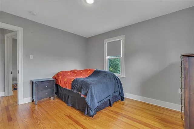 a bed sitting in a bedroom next to a window