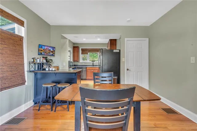 a dining room with furniture and wooden floor