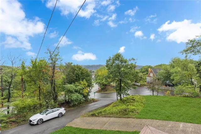 a view of a street with a car parked in front of it