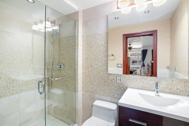 a bedroom with a bed dresser and a flat tv screen