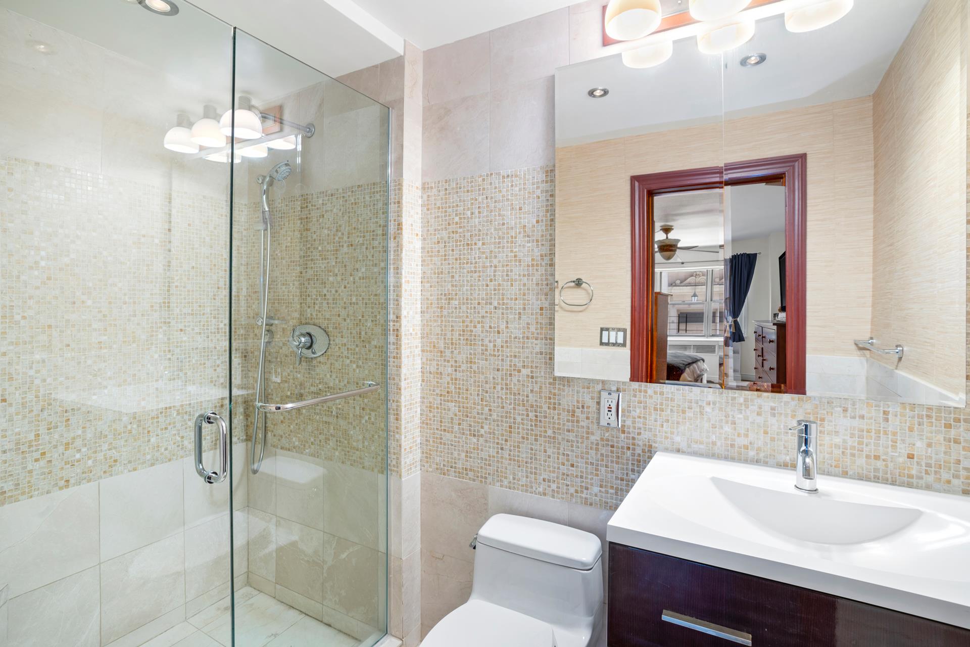 136 East 76th Street, Unit 3D Manhattan, NY 10021 - Photo 5 of 12 a bathroom with a sink toilet and shower