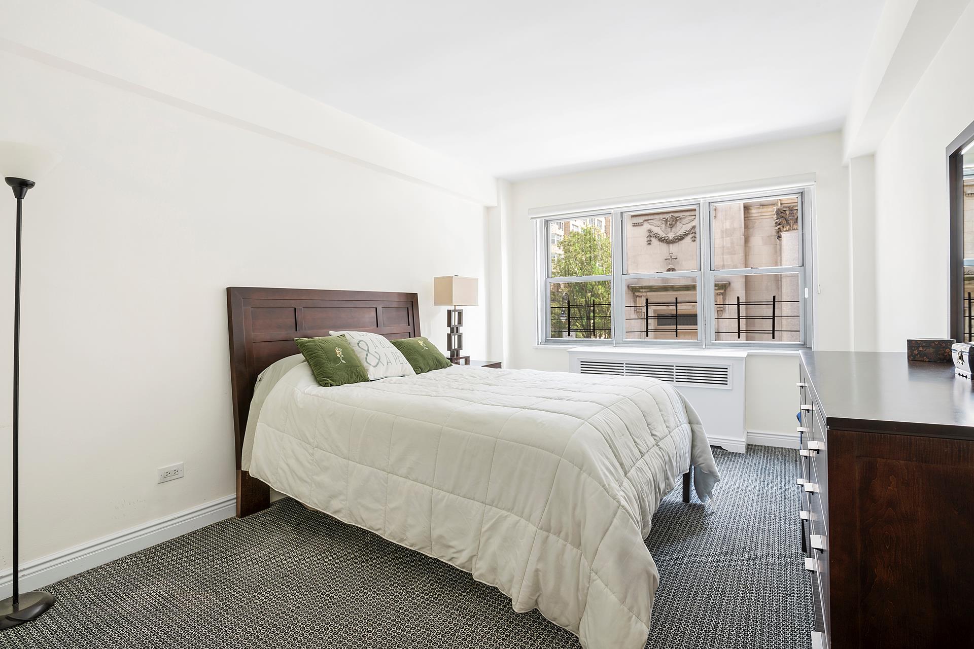136 East 76th Street, Unit 3D Manhattan, NY 10021 - Photo 6 of 12 a bedroom with a bed and a window