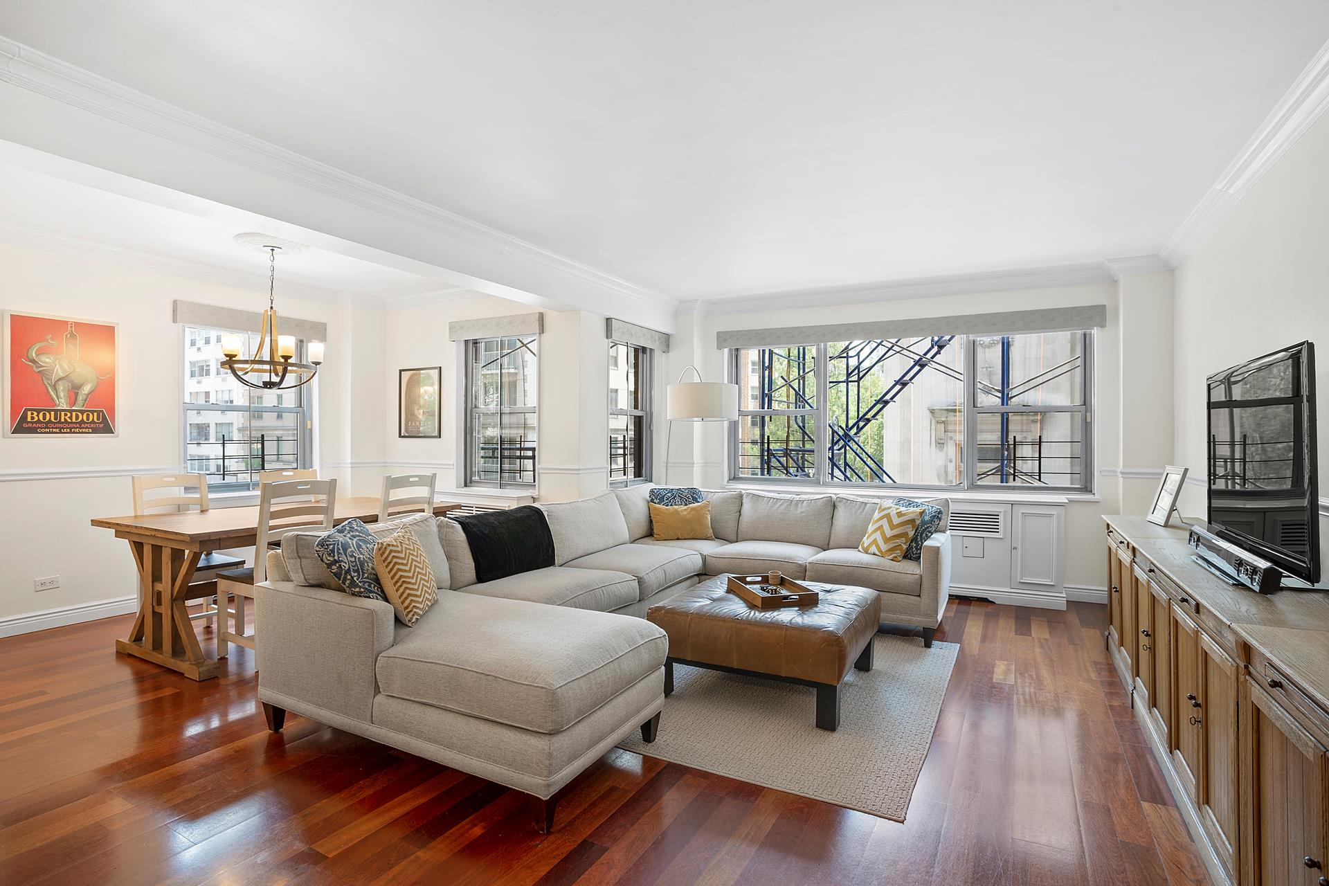 136 East 76th Street, Unit 3D Manhattan, NY 10021 - Photo 7 of 12 a living room with furniture and a flat screen tv
