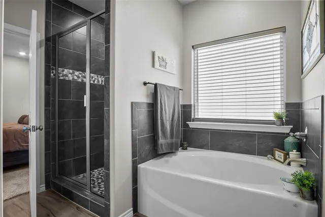 a bathroom with a bathtub and a shower