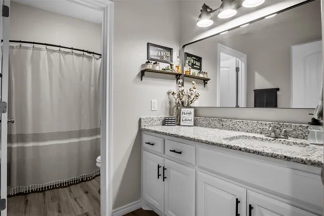 a bathroom with a double vanity sink and mirror