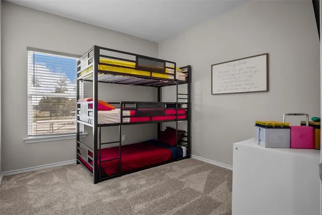 a bedroom with bed and window