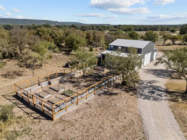 an aerial view of a house with a yard and lake view