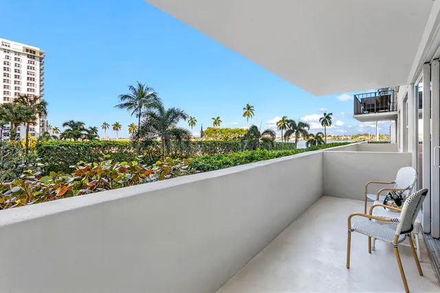 a living room with patio furniture and a wooden floor