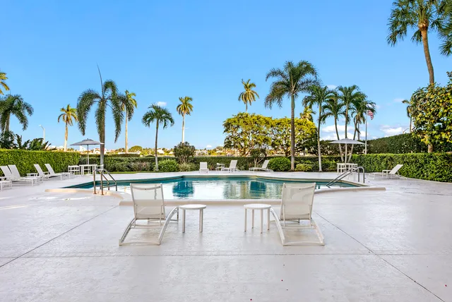 a view of pool with outdoor seating and city view