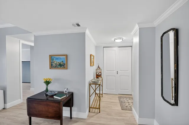 a view of a workspace with furniture and wooden floor
