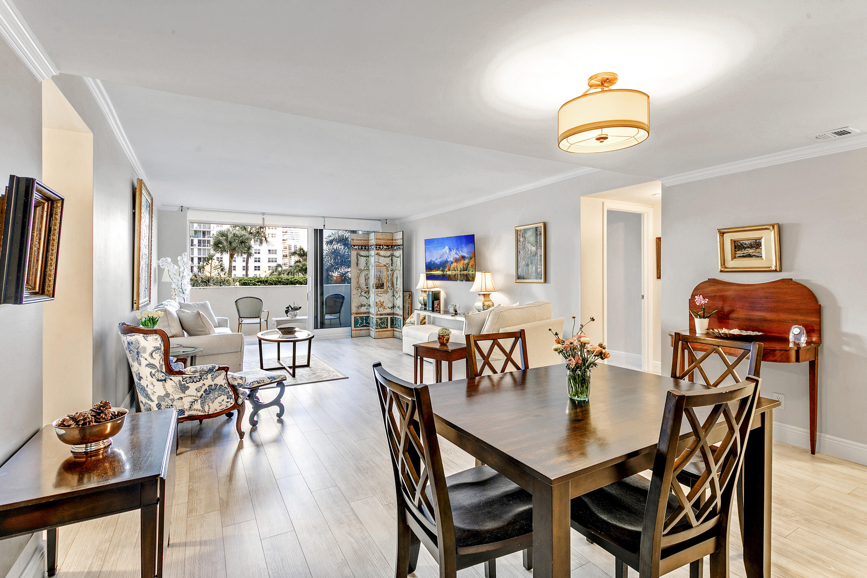 1801 South Flagler Drive, Unit 205 West Palm Beach, FL 33401 - Photo 4 of 16 a view of a dining room with furniture and wooden floor