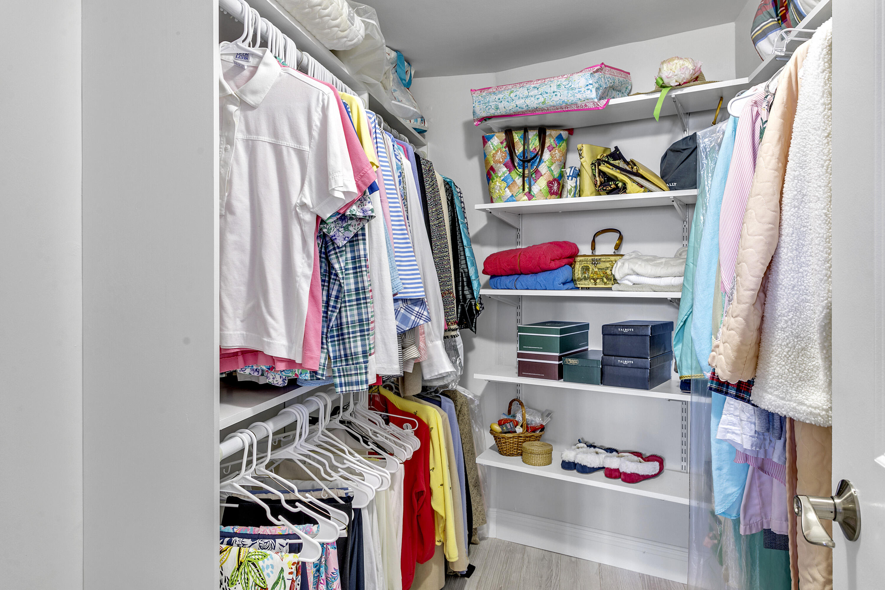 1801 South Flagler Drive, Unit 205 West Palm Beach, FL 33401 - Photo 7 of 16 a view of walk in closet with clothes and shoes