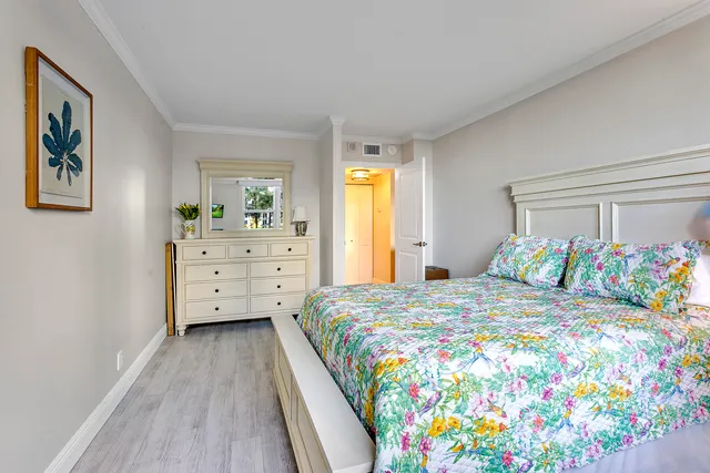 a bedroom with a bed and a dresser