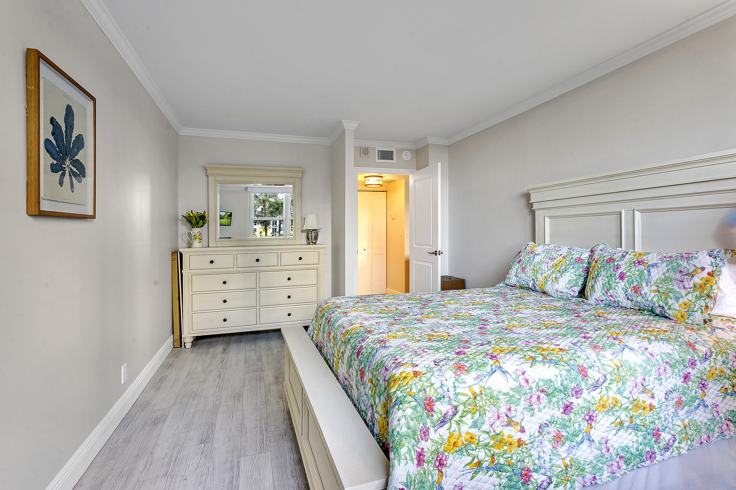 1801 South Flagler Drive, Unit 205 West Palm Beach, FL 33401 - Photo 8 of 16 a bedroom with a bed and a dresser