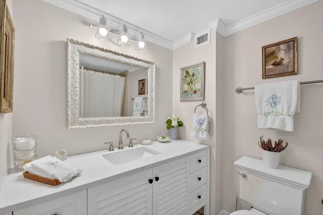 a bathroom with a granite countertop sink mirror and vanity