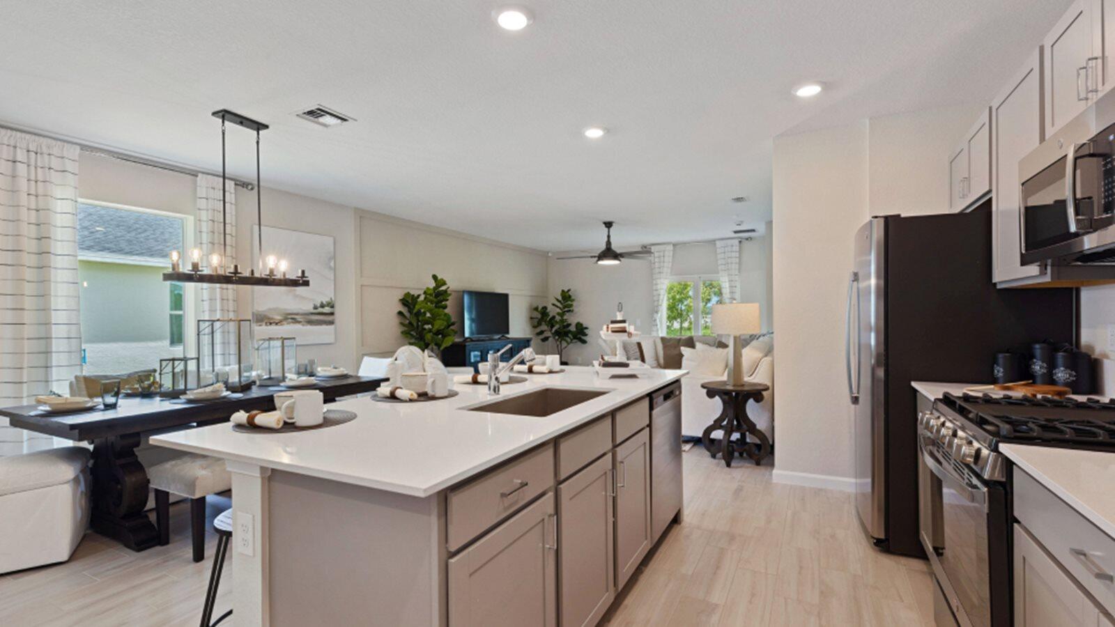2211 Marigold Trail Palm Bay, FL 32907 - Photo 3 of 17 a kitchen with a sink a stove and chairs