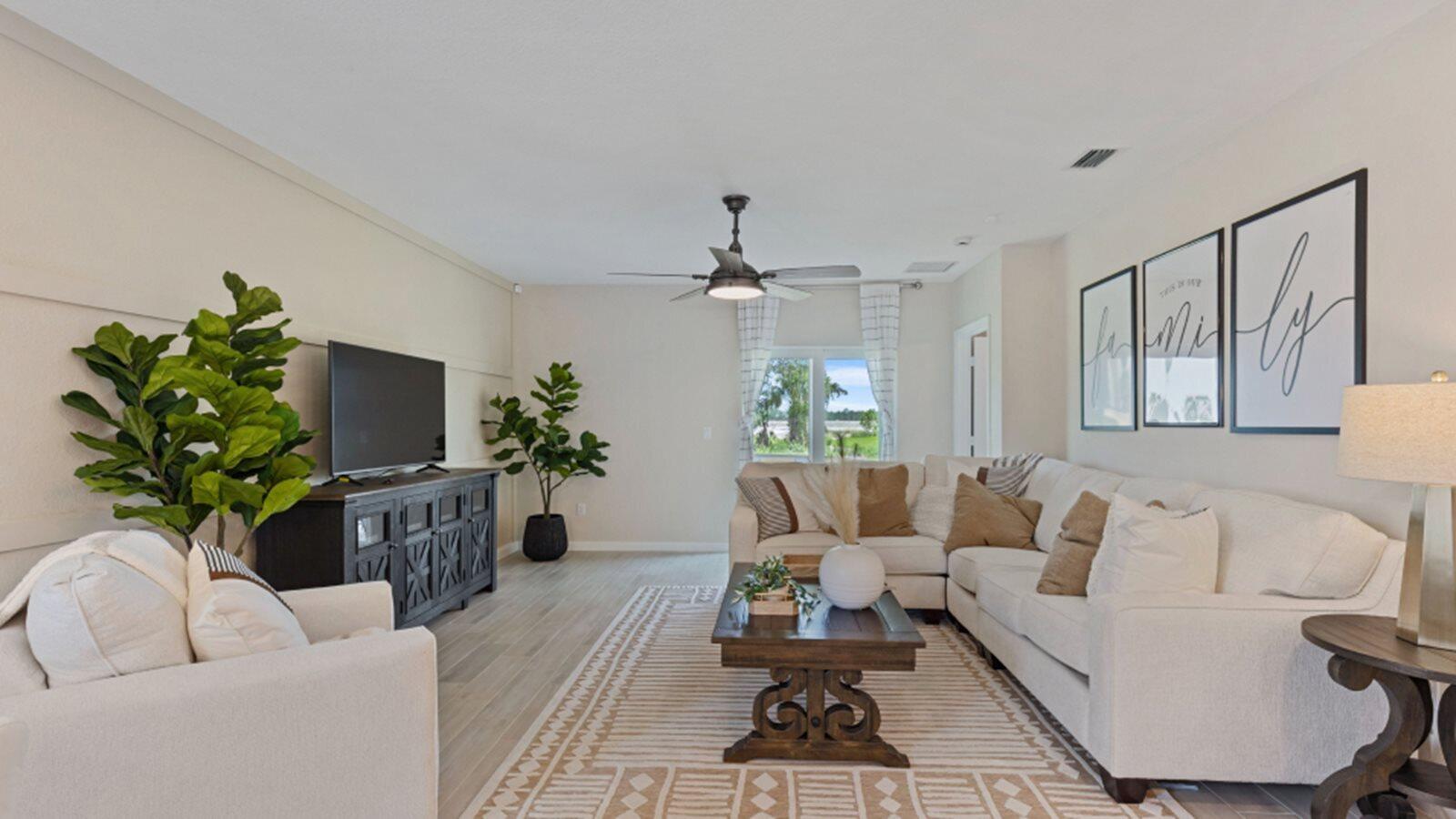 2211 Marigold Trail Palm Bay, FL 32907 - Photo 5 of 17 a living room with furniture a chandelier and a potted plant