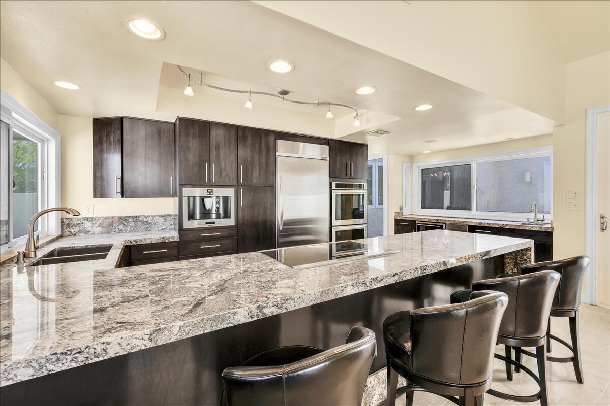 39 Santo Domingo Drive Rancho Mirage, CA 92270 - Photo 14 of 30 a large kitchen with granite countertop a counter top space appliances and cabinets