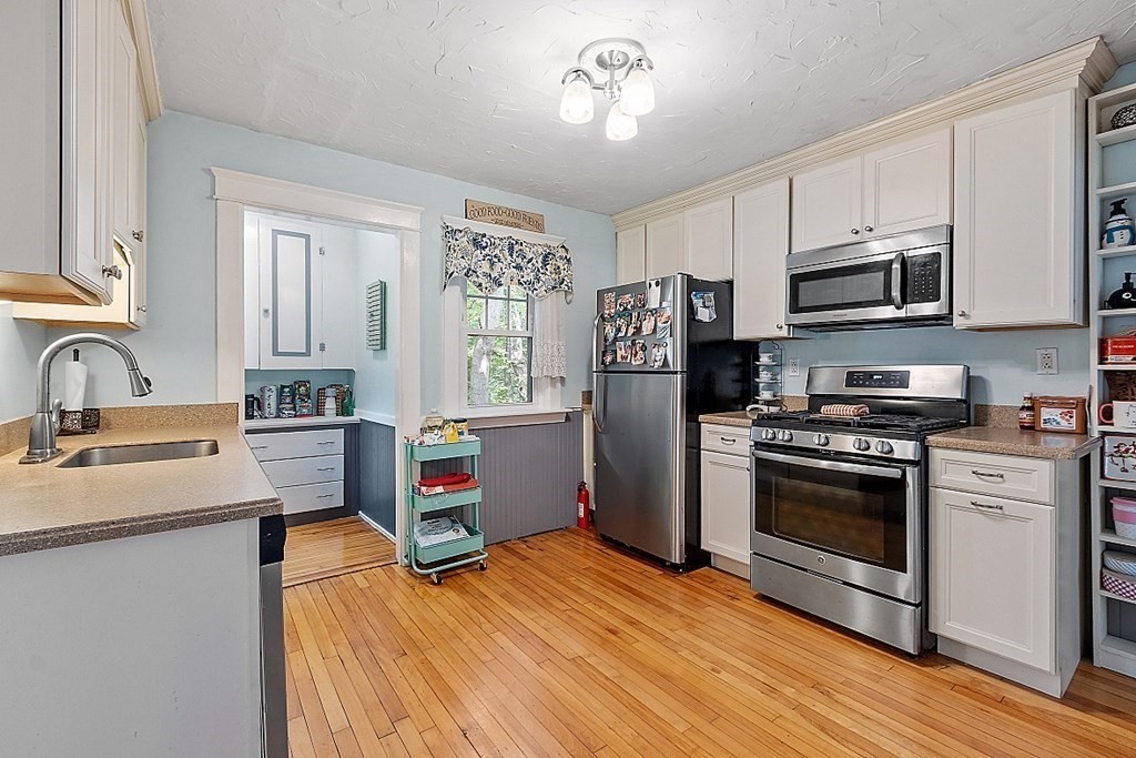 24 Maplewood Road Worcester, MA 01602 - Photo 13 of 42 a kitchen with stainless steel appliances granite countertop a refrigerator stove and sink