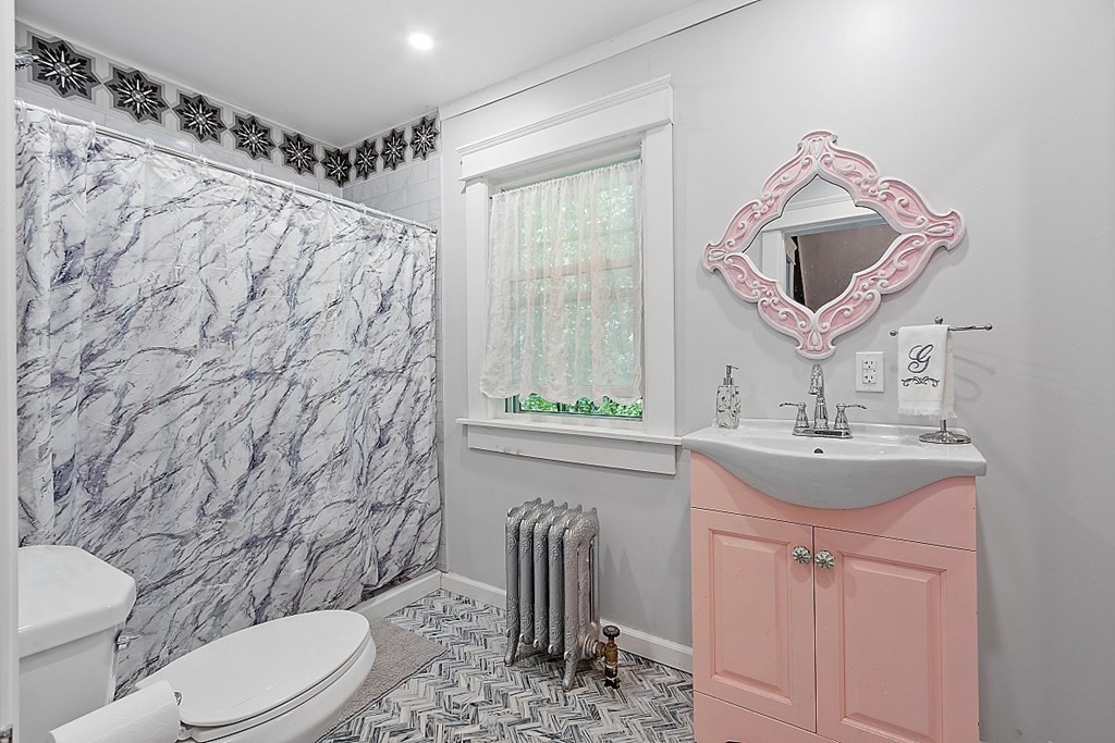 24 Maplewood Road Worcester, MA 01602 - Photo 18 of 42 a bathroom with a toilet sink and mirror
