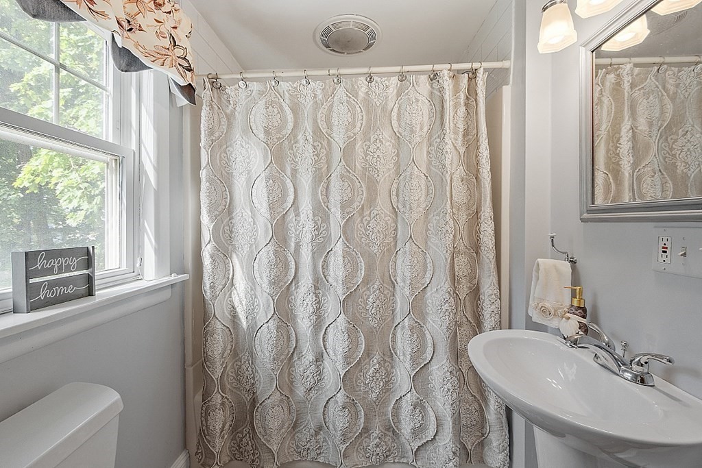 24 Maplewood Road Worcester, MA 01602 - Photo 19 of 42 a bathroom with a sink a toilet and a mirror