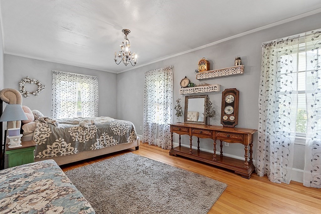 24 Maplewood Road Worcester, MA 01602 - Photo 20 of 42 a bedroom with a bed chandelier and a window