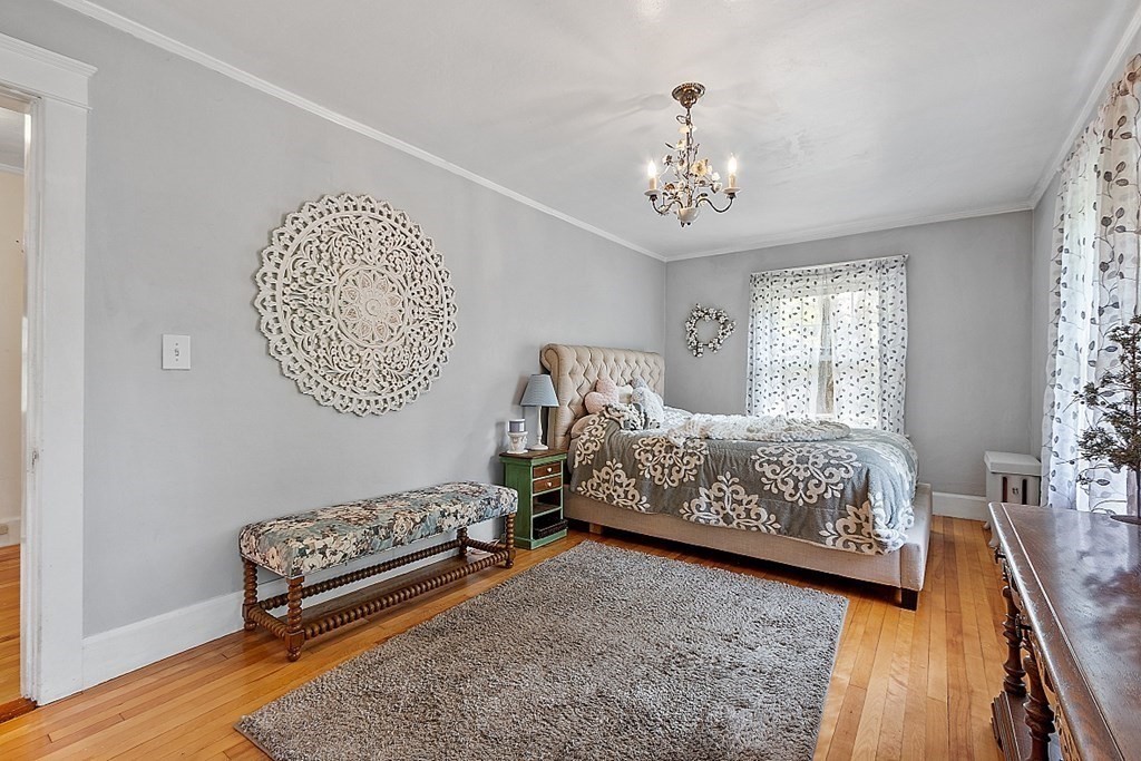 24 Maplewood Road Worcester, MA 01602 - Photo 22 of 42 a bedroom with a bed chandelier and a window