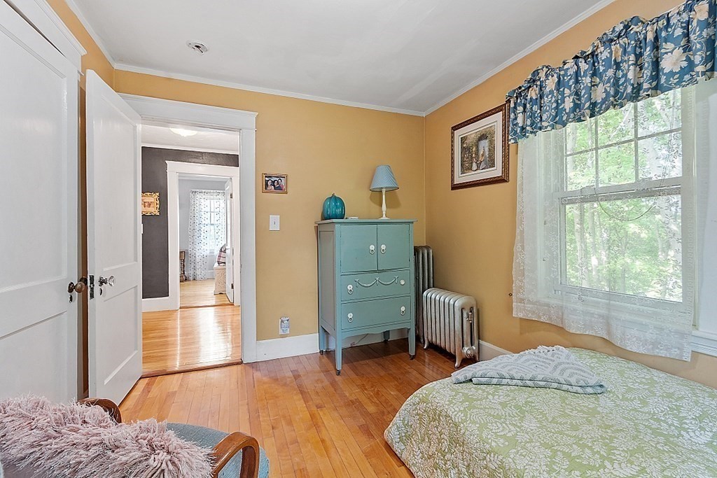 24 Maplewood Road Worcester, MA 01602 - Photo 25 of 42 a bedroom with a bed and wooden floor