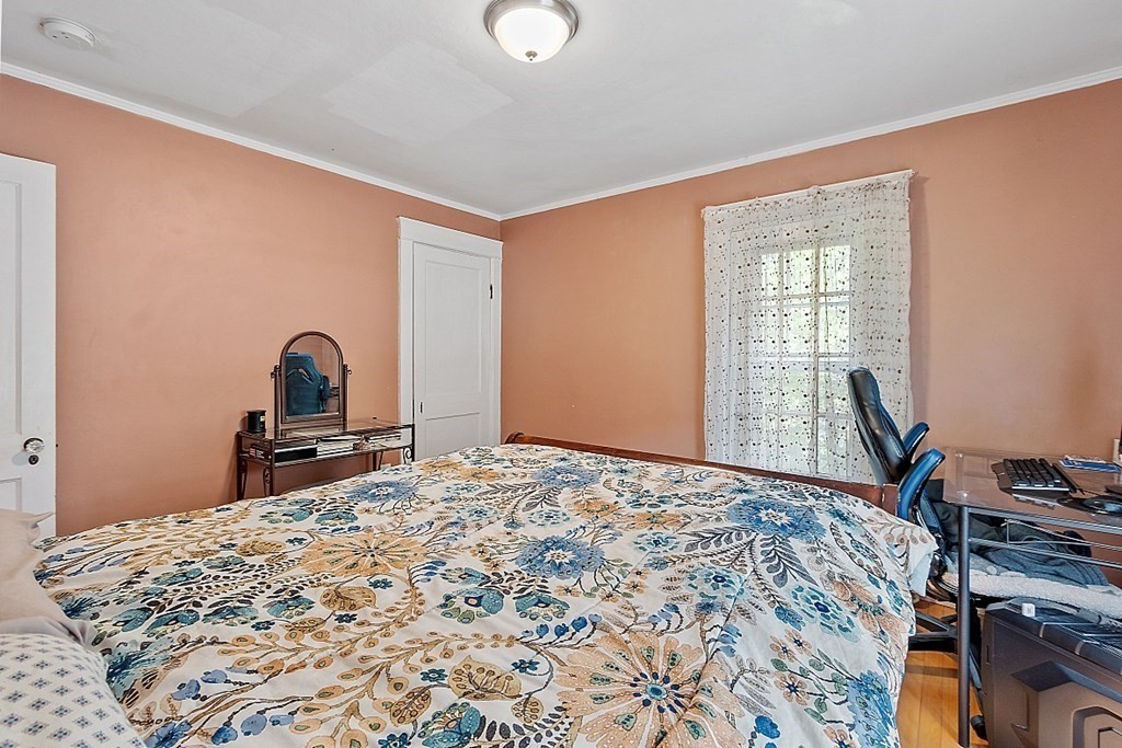 24 Maplewood Road Worcester, MA 01602 - Photo 27 of 42 a bed sitting in a bedroom next to a window